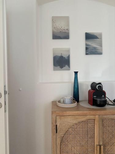 a room with a wooden cabinet with pictures on the wall at Ferienwohnung Klapothek in Leutschach