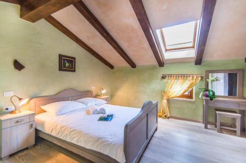 a bedroom with a large bed and a window at Villa Fumica by Villa Plus in Radetići