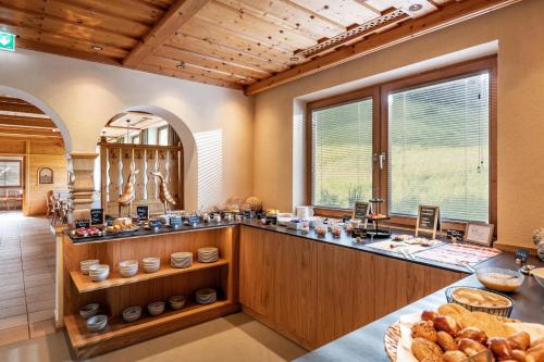 a large kitchen with a counter with bread on it at Pension Schneerose - Wildschönau - PREMIUM CARD im Sommer in Wildschönau
