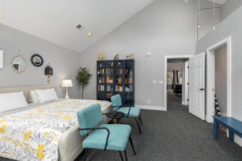 a bedroom with a bed and two blue chairs at Blue Star Motel in Douglas