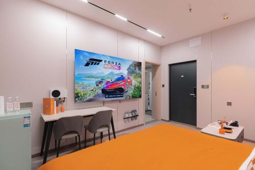 a living room with a large tv on the wall at The Bund River Prologue Residence in Shanghai