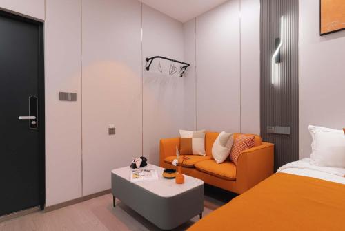 a room with a bed and a couch and a basketball hoop at The Bund River Prologue Residence in Shanghai