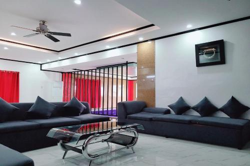 a living room with couches and a table at Jewelry Resort and Villas Tagaytay in Silang