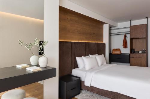 Ένα ή περισσότερα κρεβάτια σε δωμάτιο στο Blanco Athens Aparthotel