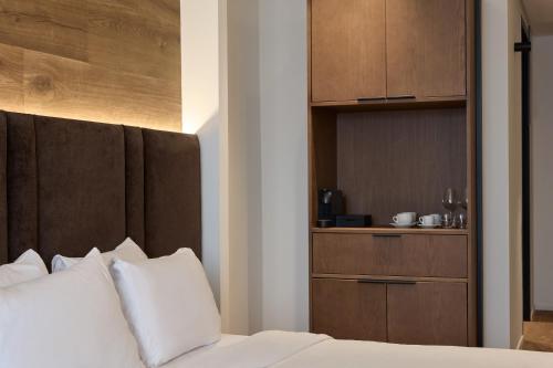 Ένα ή περισσότερα κρεβάτια σε δωμάτιο στο Blanco Athens Aparthotel