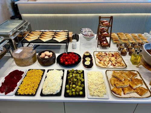 a buffet with many different types of food on a table at Asters Hotel in Ksamil