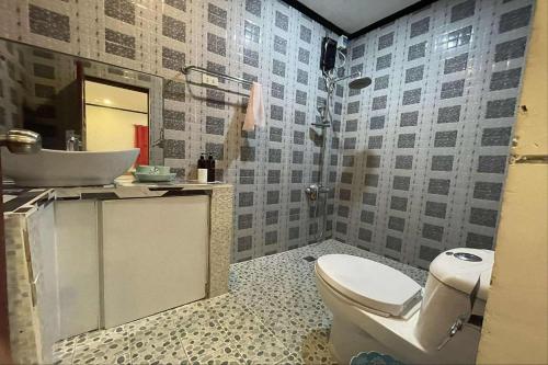 a bathroom with a sink and a toilet and a mirror at Jewelry Resort and Villas Tagaytay in Silang