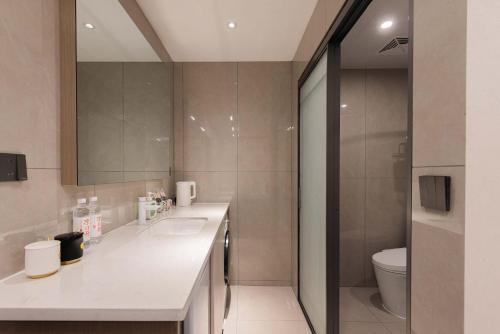 a bathroom with a sink and a toilet at The Bund River Prologue Residence in Shanghai
