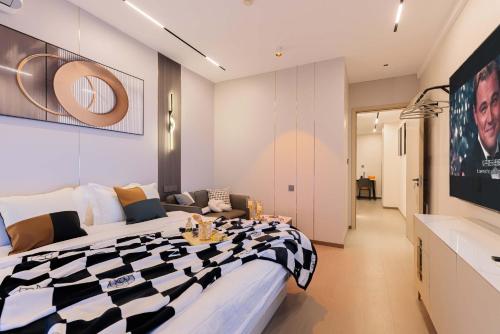 a bedroom with a black and white bed and a couch at The Bund River Prologue Residence in Shanghai
