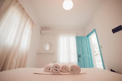 a room with towels on a bed with a window at Nerina Studios Agios Nikitas in Agios Nikitas