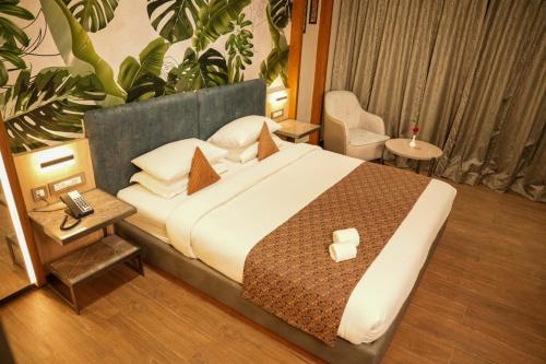 a bedroom with a large bed in a room at Menaka inn in Dhārwād