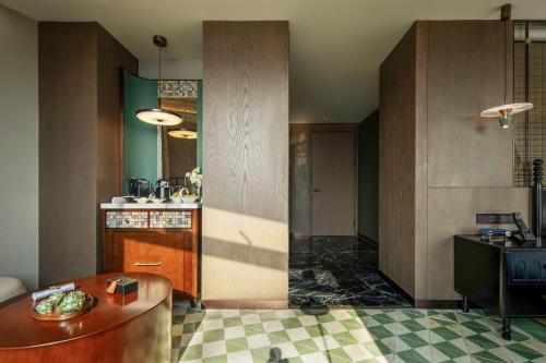 a kitchen with a table and a counter top at Xiamen Lujiang Harbourview Hotel in Xiamen