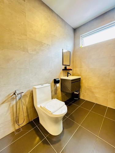 a bathroom with a toilet and a sink at LESTARI INN RESIDENCE in Kuantan