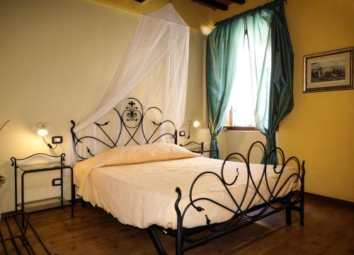a bedroom with a bed with a wrought iron headboard at Sul Prado in Pietrasanta