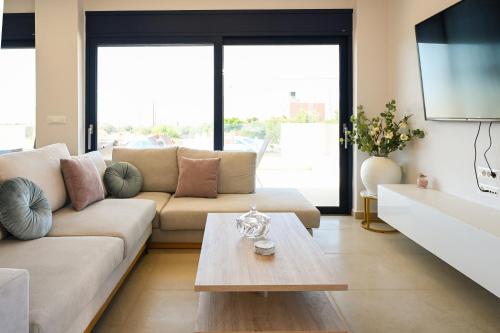 a living room with a couch and a table at Ifigenia VIlla Sissi in Sissi