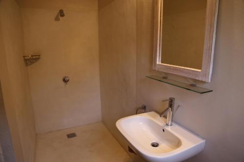 a bathroom with a sink and a mirror at Wildebeest Eco Camp in Nairobi