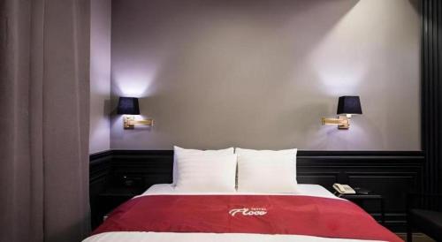 a bedroom with a red and white bed with two lights at Hotel Floce in Bucheon