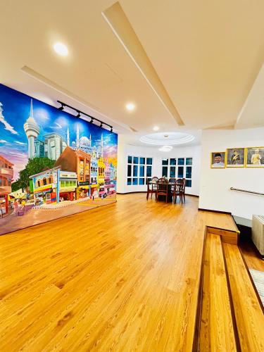 a large room with a wooden floor and a painting on the wall at LESTARI INN RESIDENCE in Kuantan
