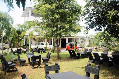a group of tables and chairs in front of a building at Grand Palace Hotel, Seeduwa in Seeduwa