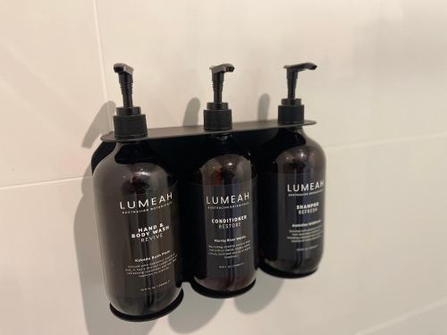 a group of three bottles of liquid on a shelf at Costello Hotels Port Augusta in Port Augusta