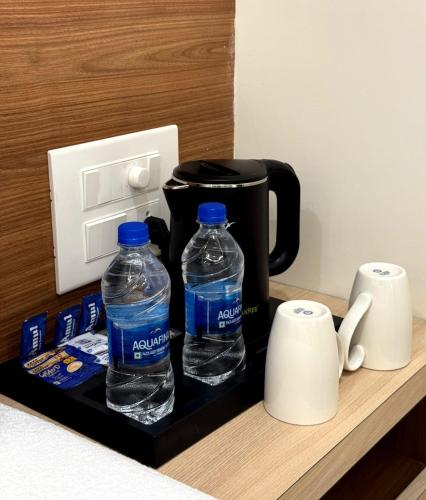 two bottles of water are sitting on a counter at Hotel Coastal Palace in Malpe