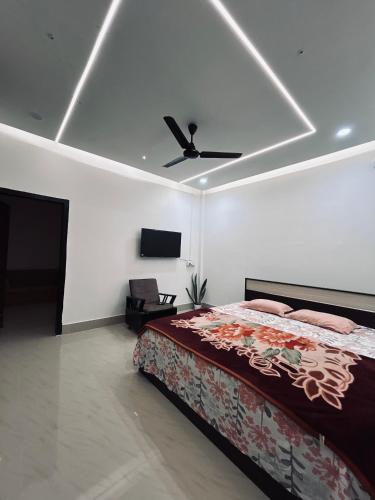 a bedroom with a bed and a ceiling fan at Euphoria escape in Tezpur