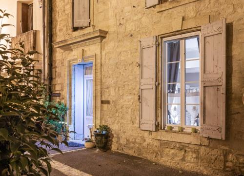 an old building with a window and a plant at L'ORANGERIE Chambres d'hotes de charme in Valros