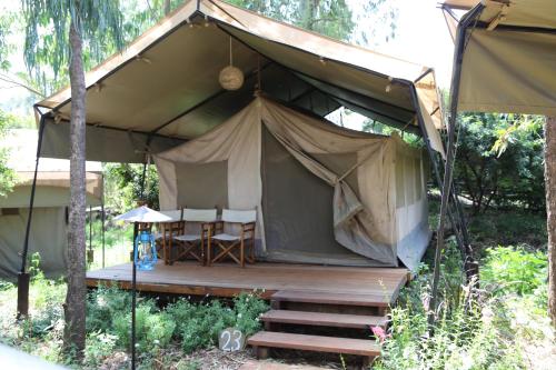 a large tent with a table and chairs in it at Wildebeest Eco Camp in Nairobi