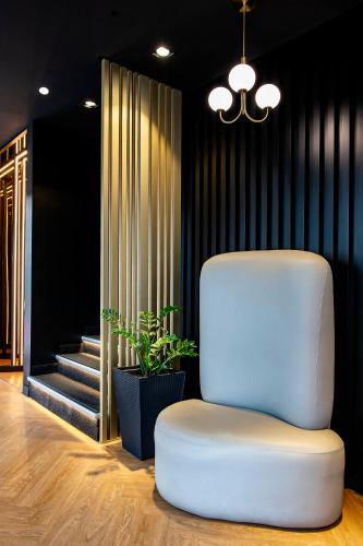a white chair in a room with a staircase at Hotel Puerto de la Luz by Pierre & Vacances in Las Palmas de Gran Canaria