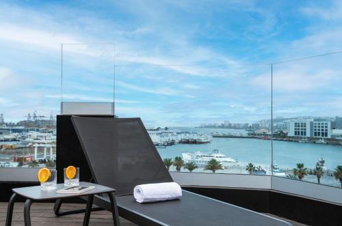 a balcony with a table and a view of a harbor at Hotel Puerto de la Luz by Pierre & Vacances in Las Palmas de Gran Canaria
