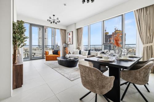 a living room with a table and chairs at 2BR plus Maid CF7 B Stylish Stay with Large Balcony in Dubai