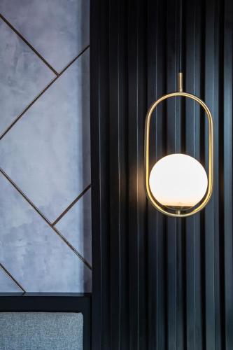 a gold light fixture hanging from a wall at Hotel Puerto de la Luz by Pierre & Vacances in Las Palmas de Gran Canaria