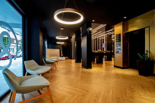 a lobby with chairs and a table in a building at Hotel Puerto de la Luz by Pierre & Vacances in Las Palmas de Gran Canaria