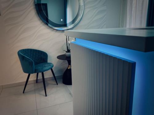 a room with a chair and a table and a mirror at Duna Corner Panzió in Verőce