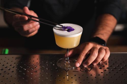 a bartender is stirring a cocktail with a stick at Tenuta Madre Vita in Siracusa
