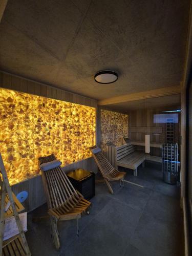 a waiting room with two chairs and a wall with yellow flowers at Pod Gwiazdami in Cisna