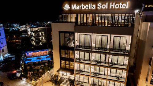 a tall building with a sign on top of it at Marbella Sol Hotel - Only Adults in Ksamil