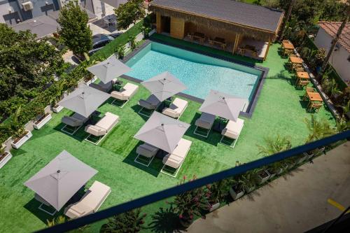 an overhead view of a pool with chairs and umbrellas at Marbella Sol Hotel - Only Adults in Ksamil