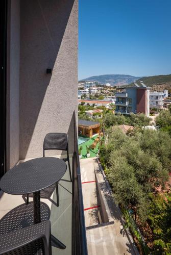 a balcony with a table and a view of a city at Marbella Sol Hotel - Only Adults in Ksamil
