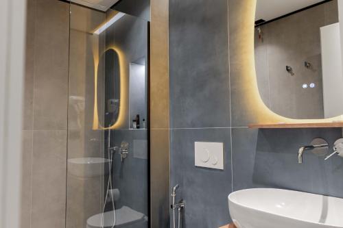 a bathroom with a shower and a sink and a mirror at Marbella Sol Hotel - Only Adults in Ksamil