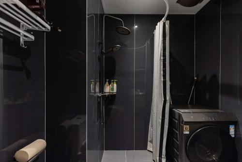 a bathroom with a shower and a washing machine at The Bund River Prologue Residence in Shanghai