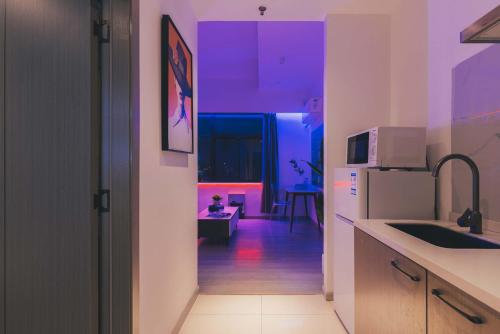 a kitchen with purple lights on the walls at The Bund River Prologue Residence in Shanghai