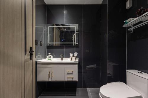 a bathroom with a sink and a toilet at The Bund River Prologue Residence in Shanghai