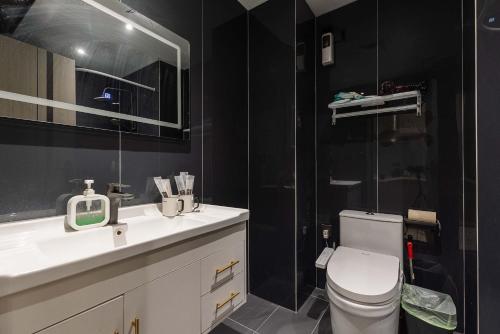 a bathroom with a toilet and a sink and a shower at The Bund River Prologue Residence in Shanghai