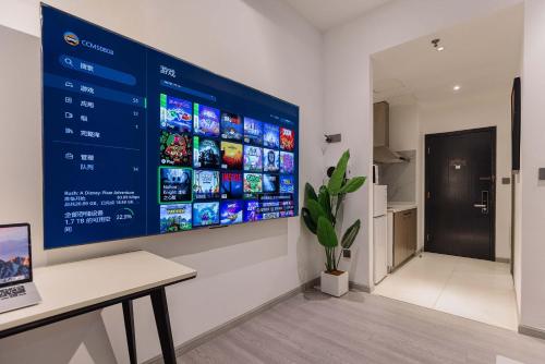 a large screen on a wall in a room at The Bund River Prologue Residence in Shanghai