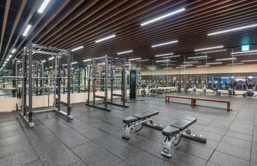 a gym with a row of machines and a bench at Hilton Clark Sun Valley Resort in Clark