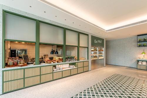 a store with glass doors and a counter with food at EVEN Hotel Guangzhou Baiyun Station by IHG - Free Shuttle Bus to Canton Fair Complex During Canton Fair Period in Guangzhou
