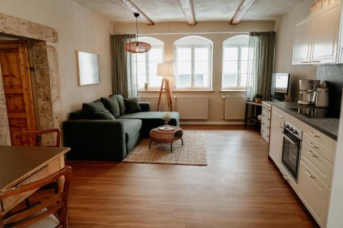 a living room with a couch and a table at Urlaubsfreude Biedermann Haus Blumenglück - Anemone in Sebnitz