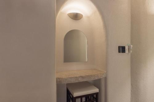 a bathroom with a sink and a mirror on the wall at Cave Ryokan Hotel by Aank Sungshin Women's University in Seoul