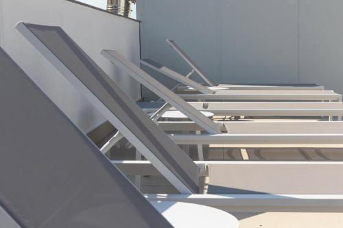 a set of stairs in a room with a wall at Hotel Calella by Beatriz Hoteles in Calella